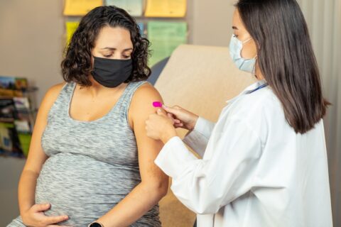 pregnant woman receiving a vaccination