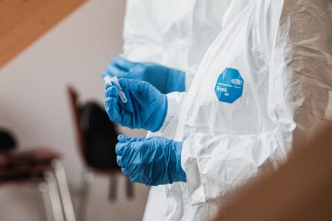 person with gloves processing a respiratory sample
