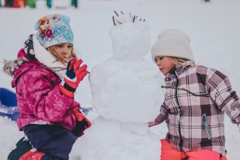 child and mom playing in snow